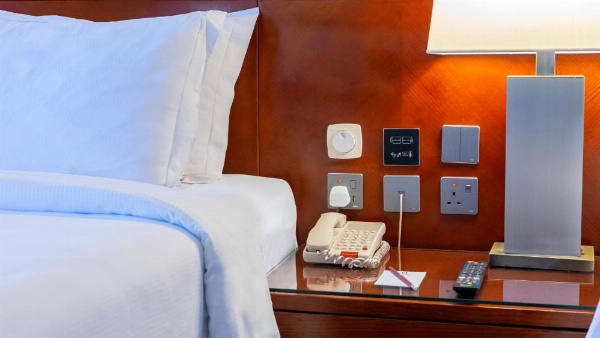 King bed with wood-paneled headboard at Al Safwah Hotel 3.