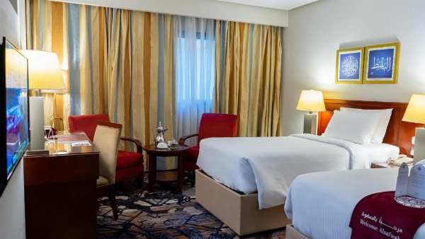 Twin room with draped curtains at Al Safwah Hotel 3.